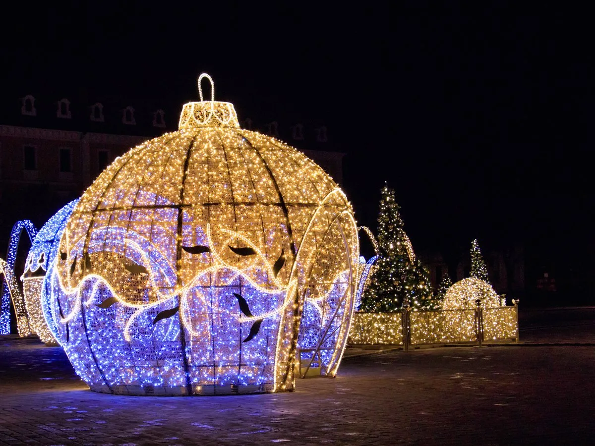 A giant illuminated ornament display at a Christmas light show, lit up at night
